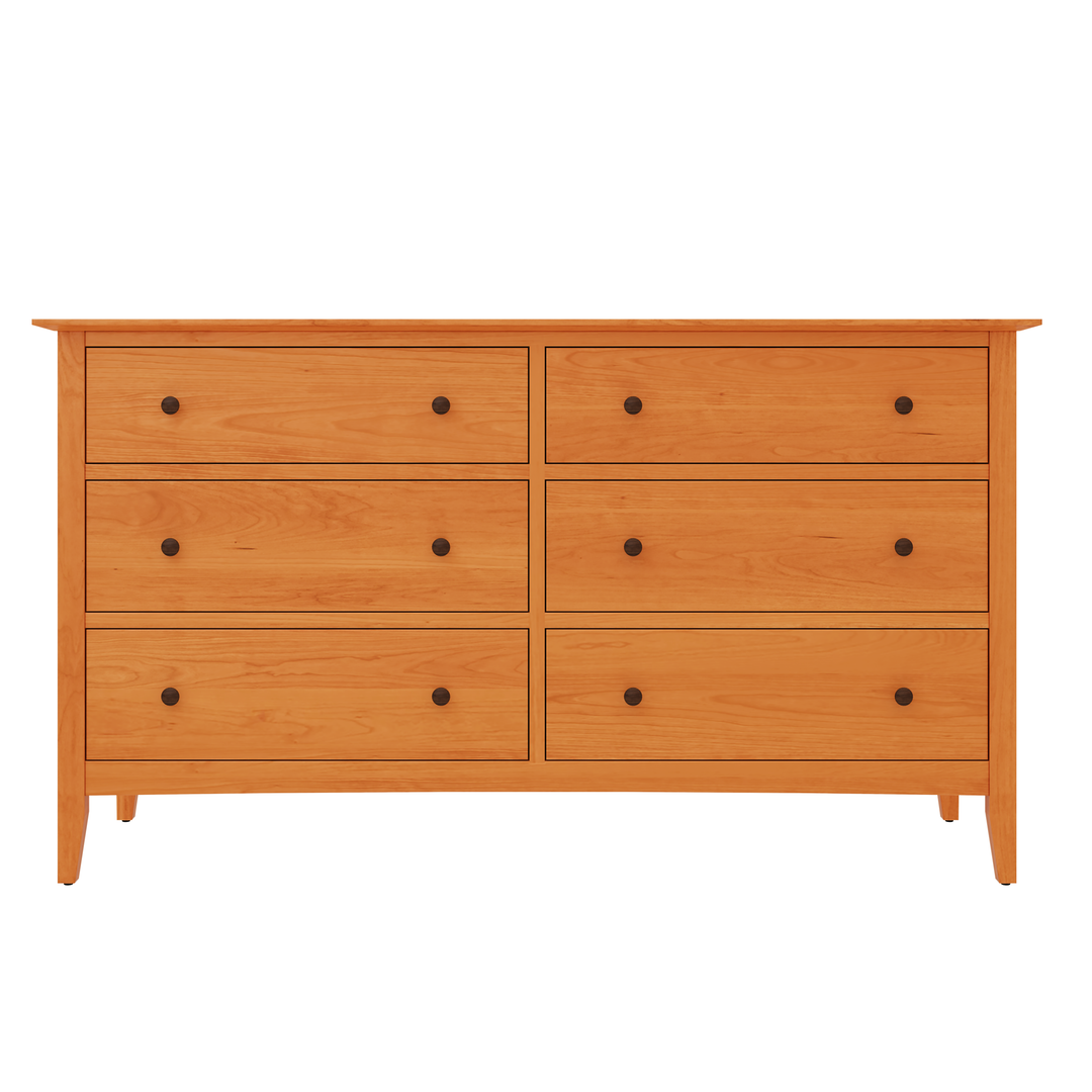 A sleek Vermont Furniture Design, six drawer double dresser shown in natural cherry sold wood.